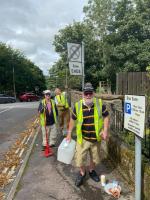 Rotarians muck in to clean the town signs..